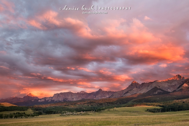 Mountains in the San Juan's of Colorado glow as sunset lights up storm clouds in the southeast.